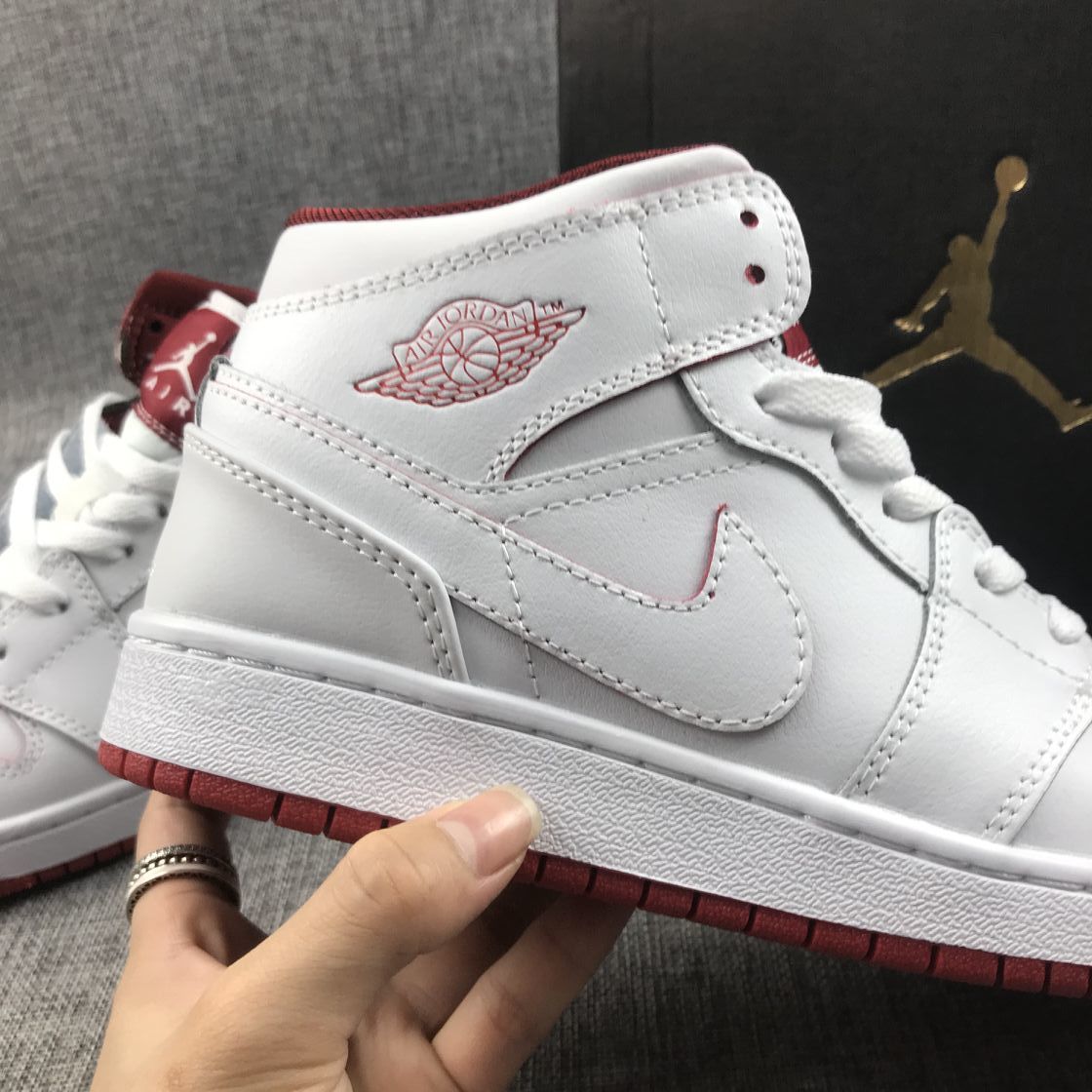 Air Jordan 1 Mid Sneakers in White and Red 554725-103 - product image from the listing.