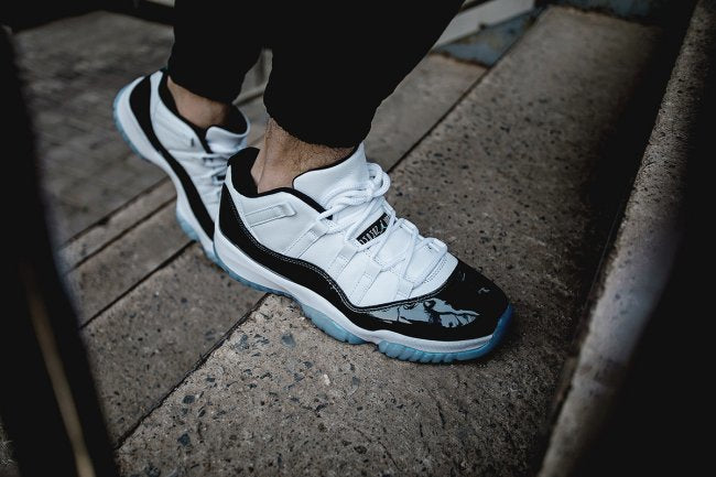 White and Black Air Jordan 11 Iridescent Sneakers - product image from the listing.
