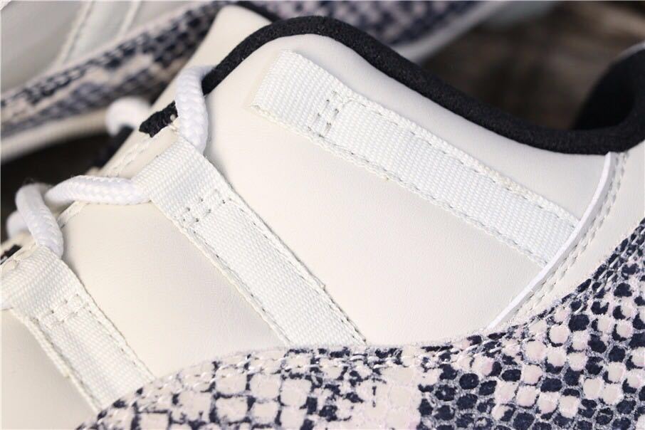 Air Jordan 11 Retro Low White Black Snakeskin Sneakers - product image from the listing.