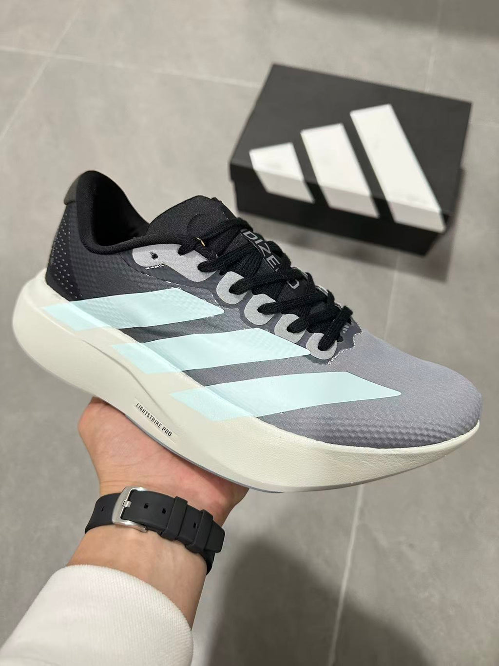 Gray and Blue Adidas Lightstrike Pro Running Shoes - product image from the listing.