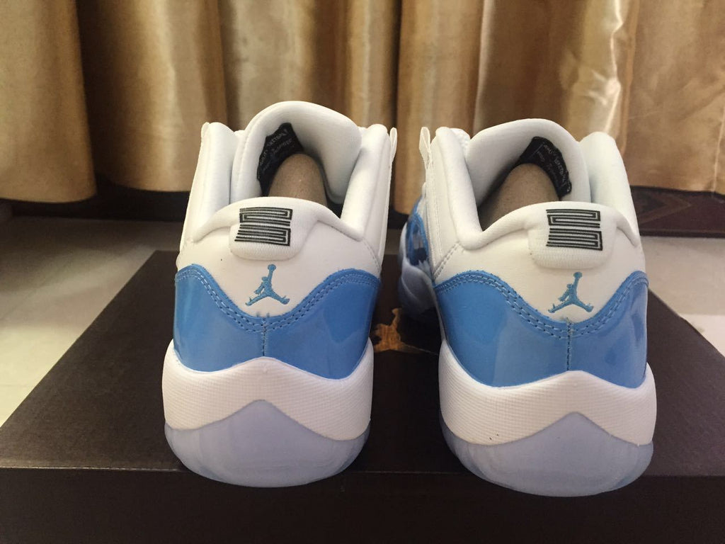 White and University Blue Jordan 11 Low Sneakers - product image from the listing.