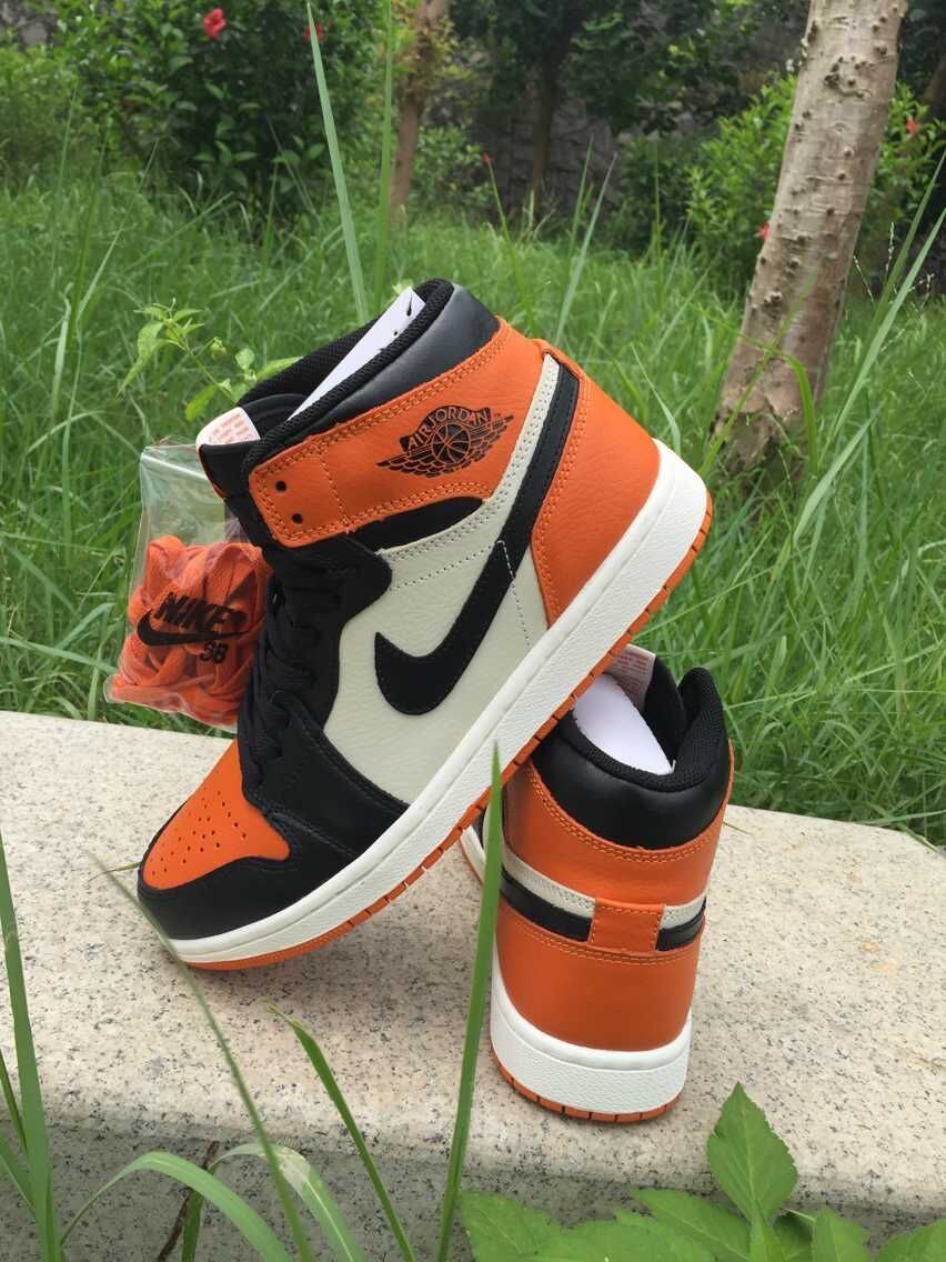 Jordan 1 High Sneakers in Black, in White and Orange - product image from the listing.