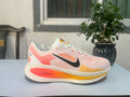 Nike Vomero 18 Running Shoes, in White and Coral - product image from the listing.