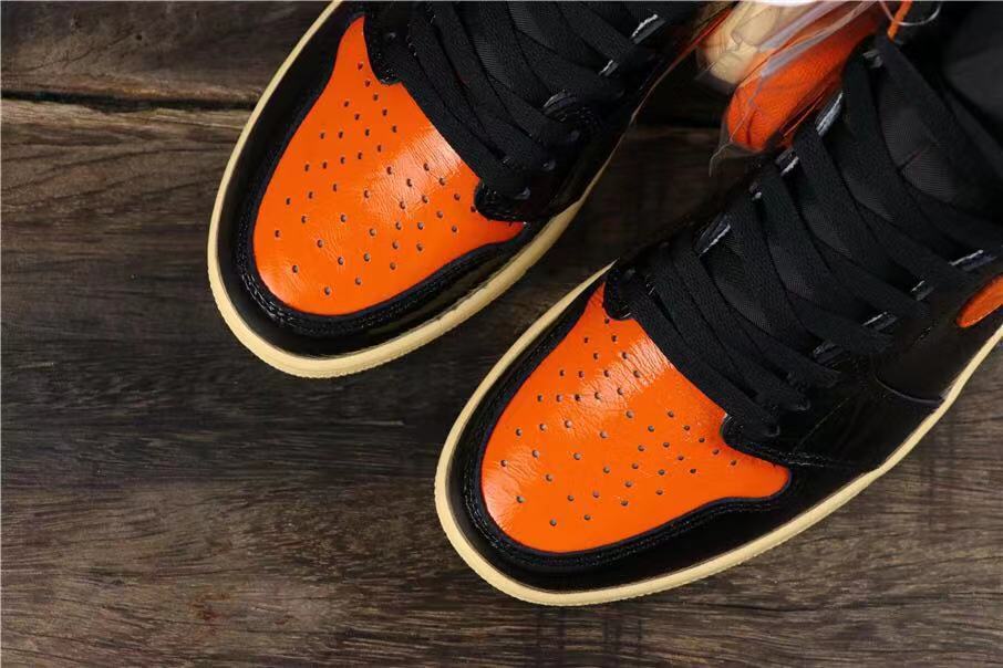 Air Jordan 1 Retro High OG Sneakers in Black and Orange - product image from the listing.