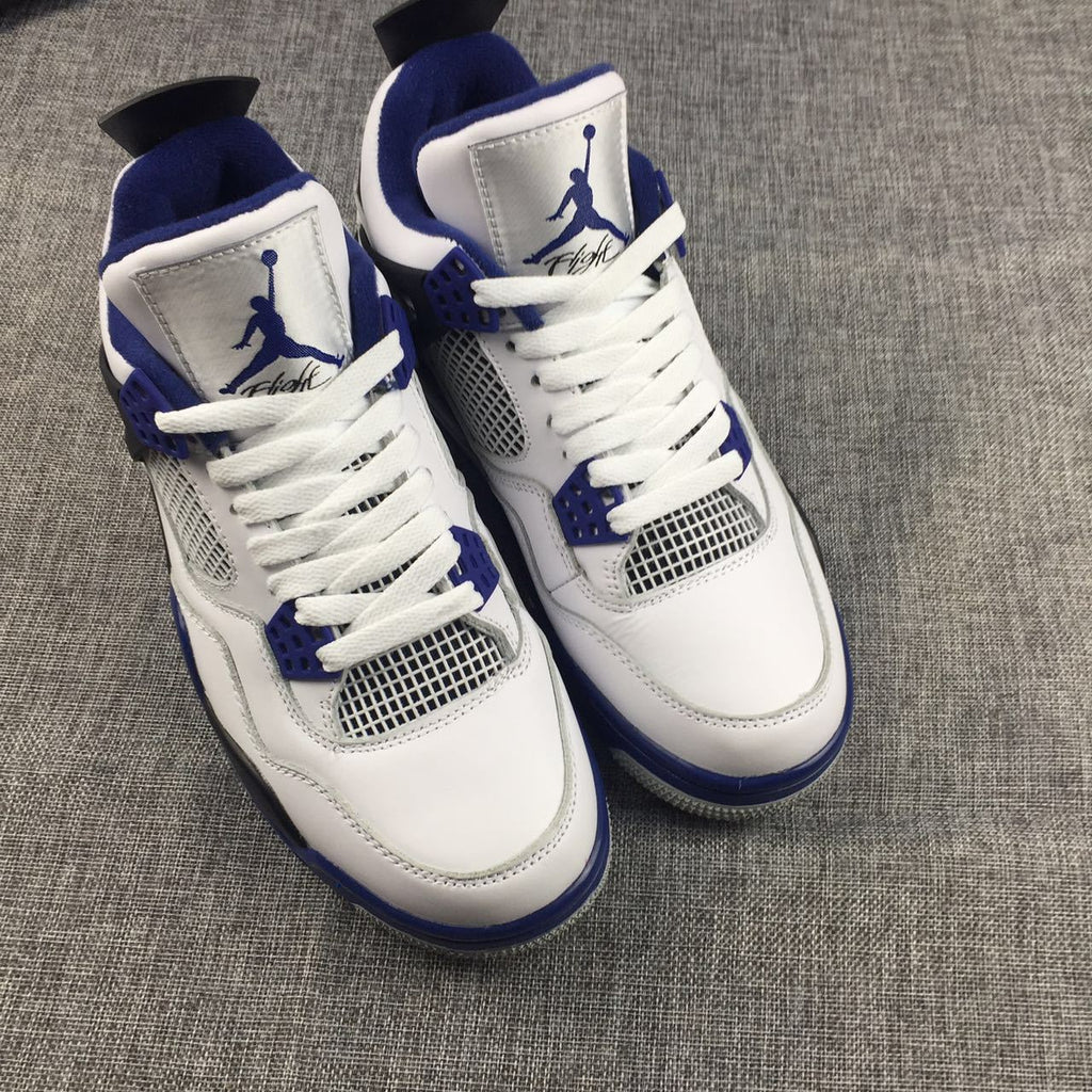 Air Jordan 4 Sneakers in White, Black and Blue - product image from the listing.