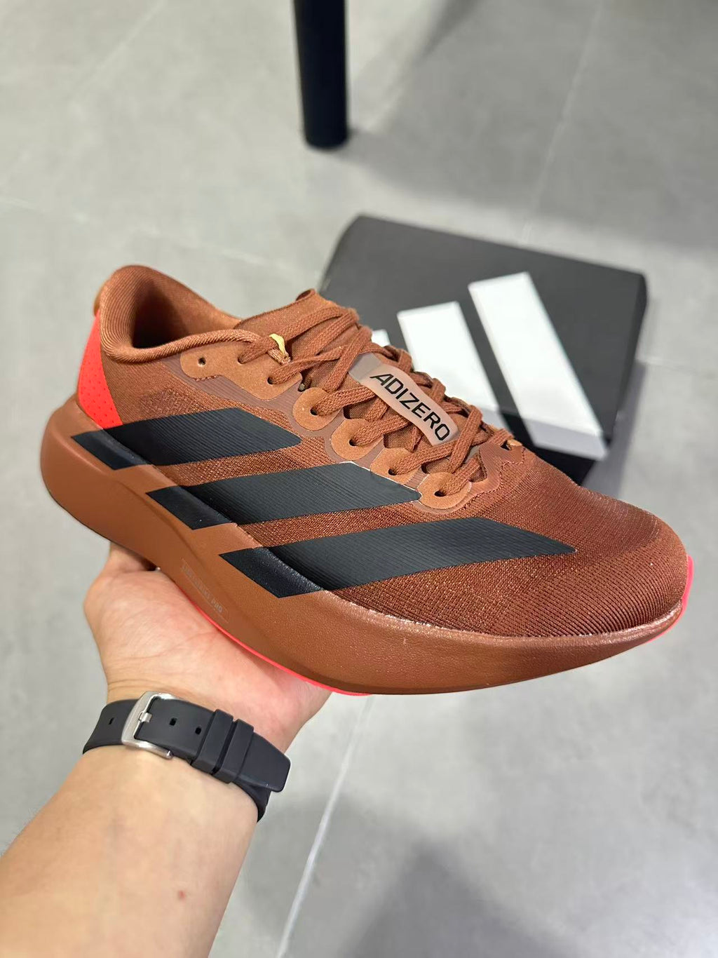 Adizero Lightstrike Pro Running Shoes, in Brown and Black KJ8809 - product image from the listing.