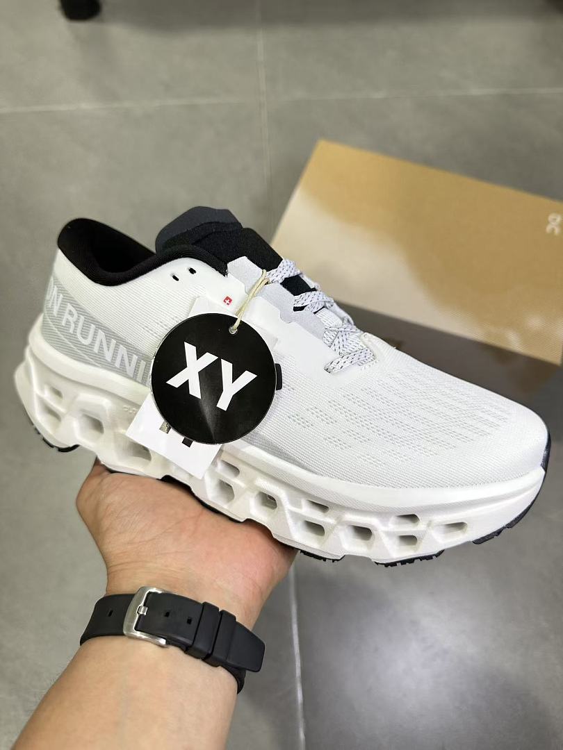 On Running Running Shoes in White and Black - product image from the listing.