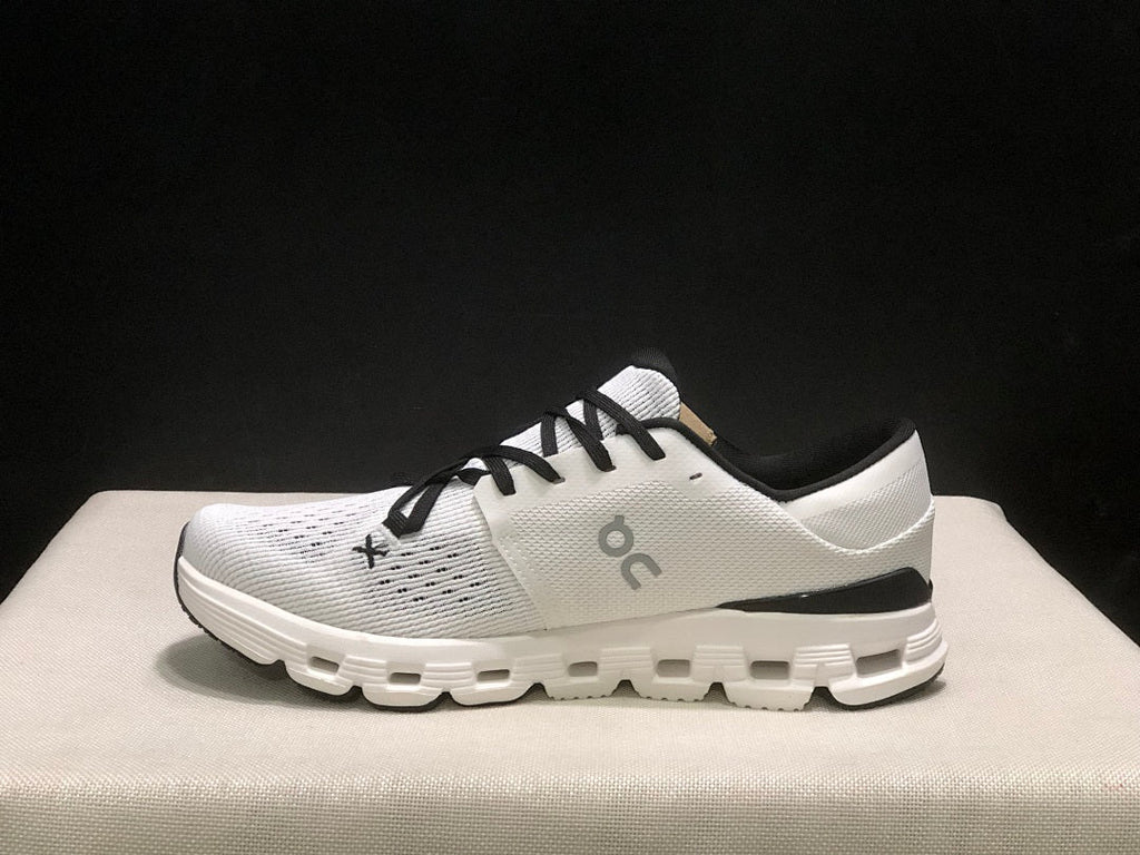 On Cloud X 4 Sneakers in Ivory and Black - product image from the listing.