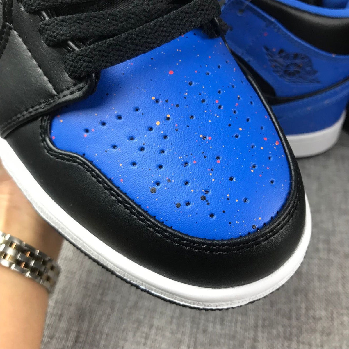 Air Jordan 1 Mid High-Top Sneakers in Black and Blue - product image from the listing.