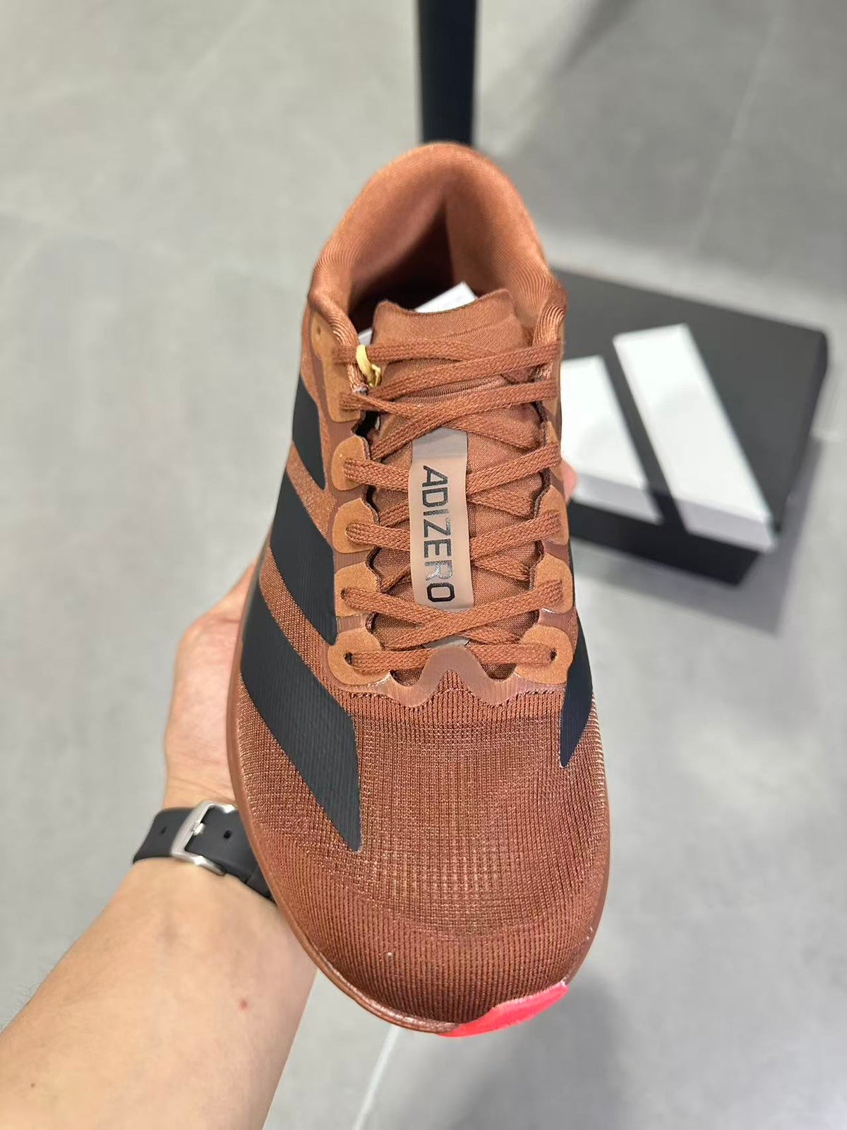 Adizero Lightstrike Pro Running Shoes, in Brown and Black KJ8809 - product image from the listing.