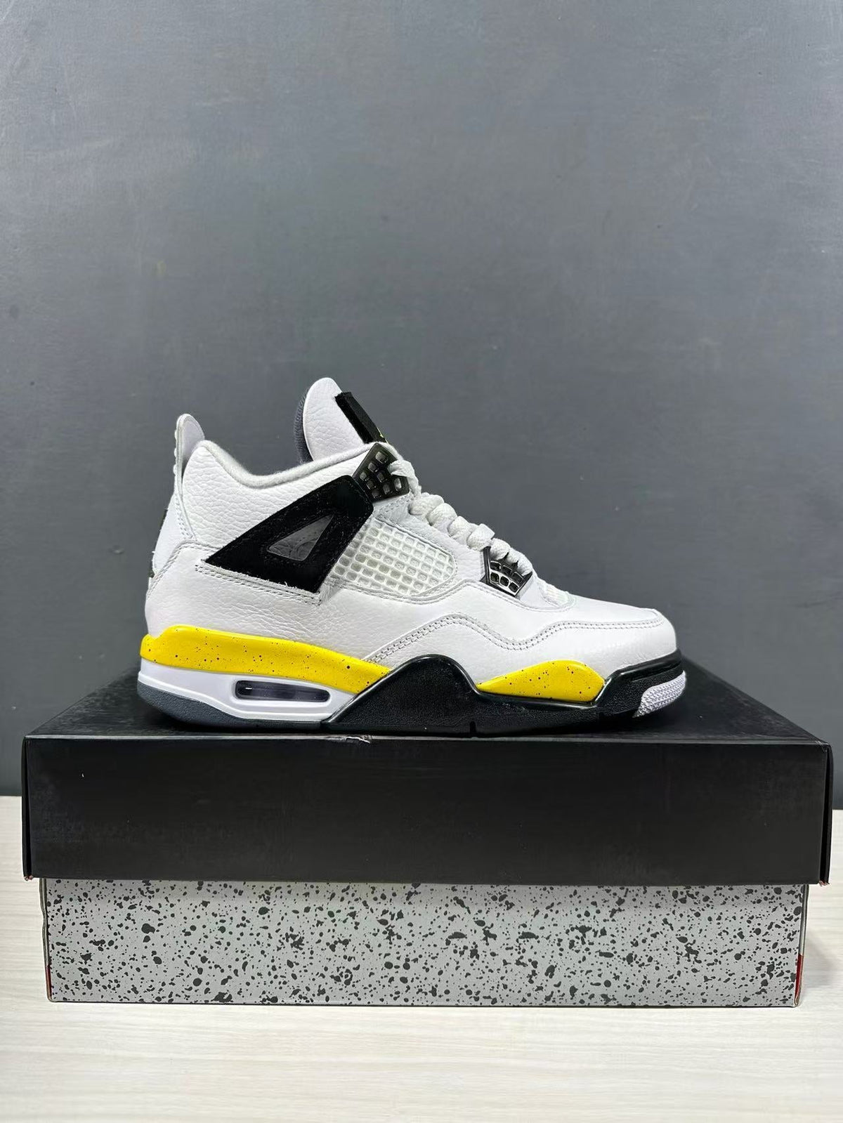 Air Jordan 4 Retro White Yellow Black Sneakers IO2468-102 - product image from the listing.
