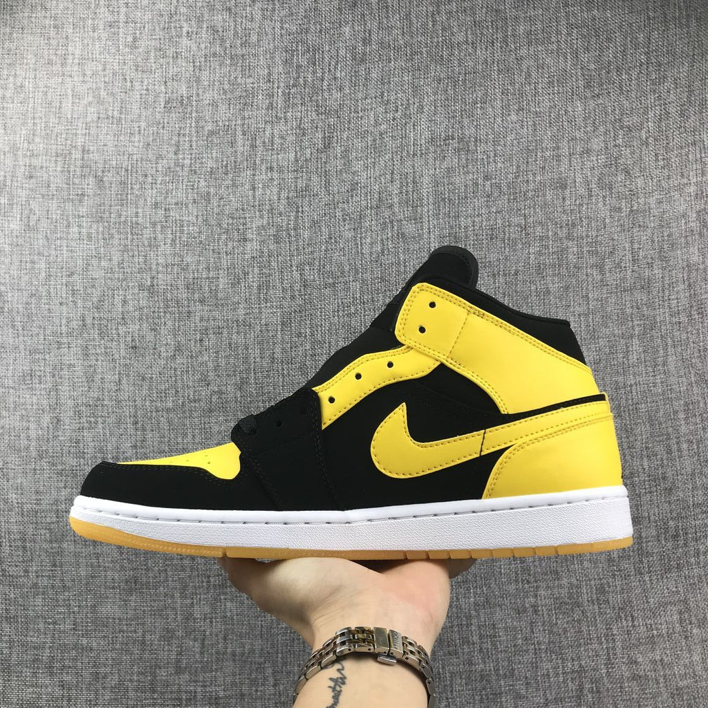 Air Jordan 1 Mid Sneakers in Black and Yellow - product image from the listing.