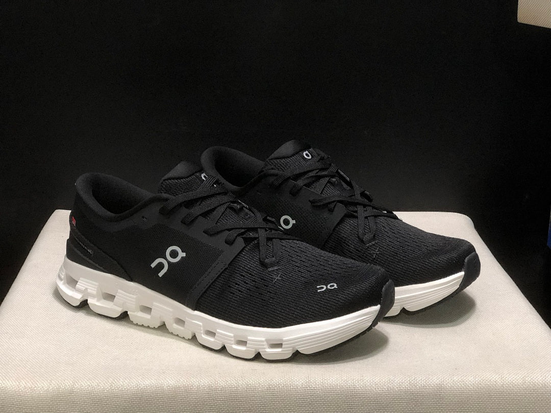 On Cloud X 4 Sneakers in Black and White - product image from the listing.