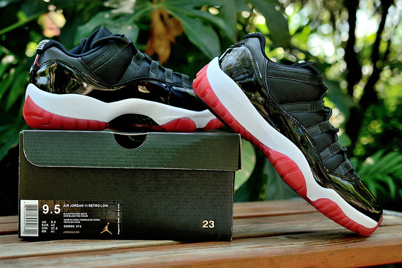Air Jordan 11 Retro Low Black and Red Sneakers - product image from the listing.