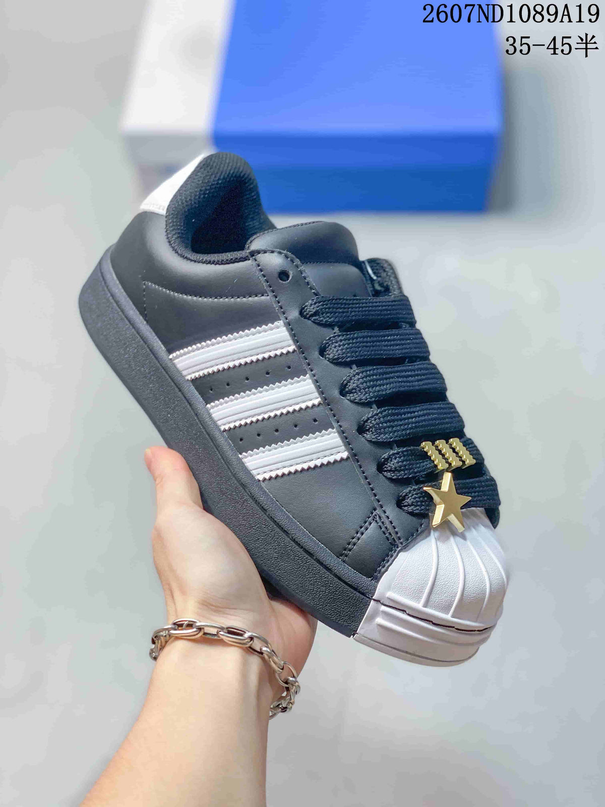adidas Superstar Shell-Toe Sneakers in Black and White - product image from the listing.