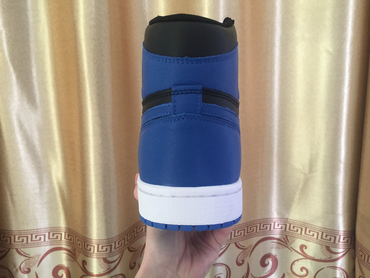 Jordan 1 High Sneakers in Black and Royal Blue - product image from the listing.