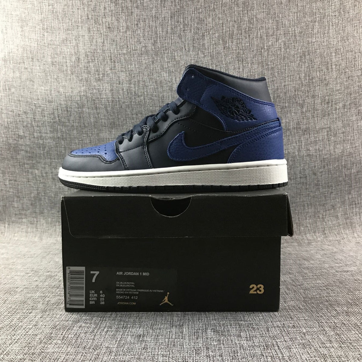 Air Jordan 1 Mid High-Top Sneakers in Black and Royal Blue - product image from the listing.