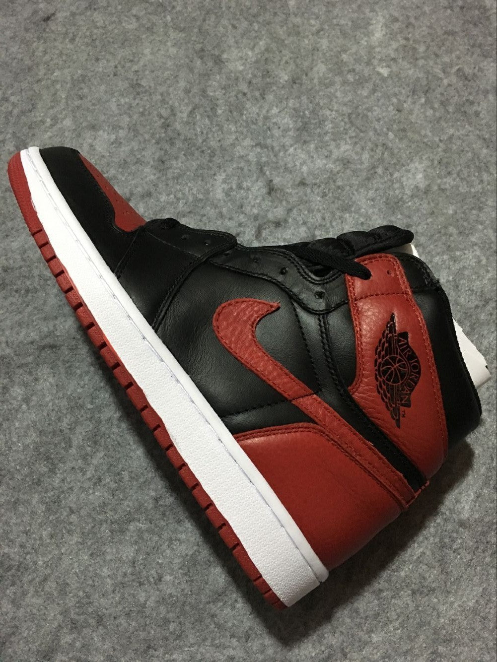 Air Jordan 1 High Sneakers in Black and Red - product image from the listing.