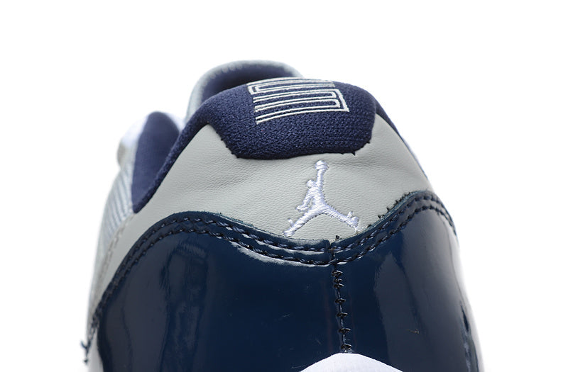 Air Jordan 11 Retro Low Sneakers, White and Navy - product image from the listing.