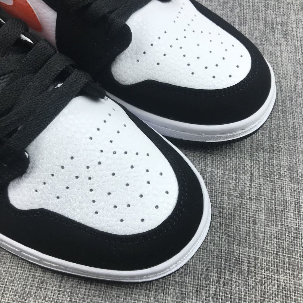 Air Jordan 1 Mid Sneakers in Black White Orange 554724-058 - product image from the listing.