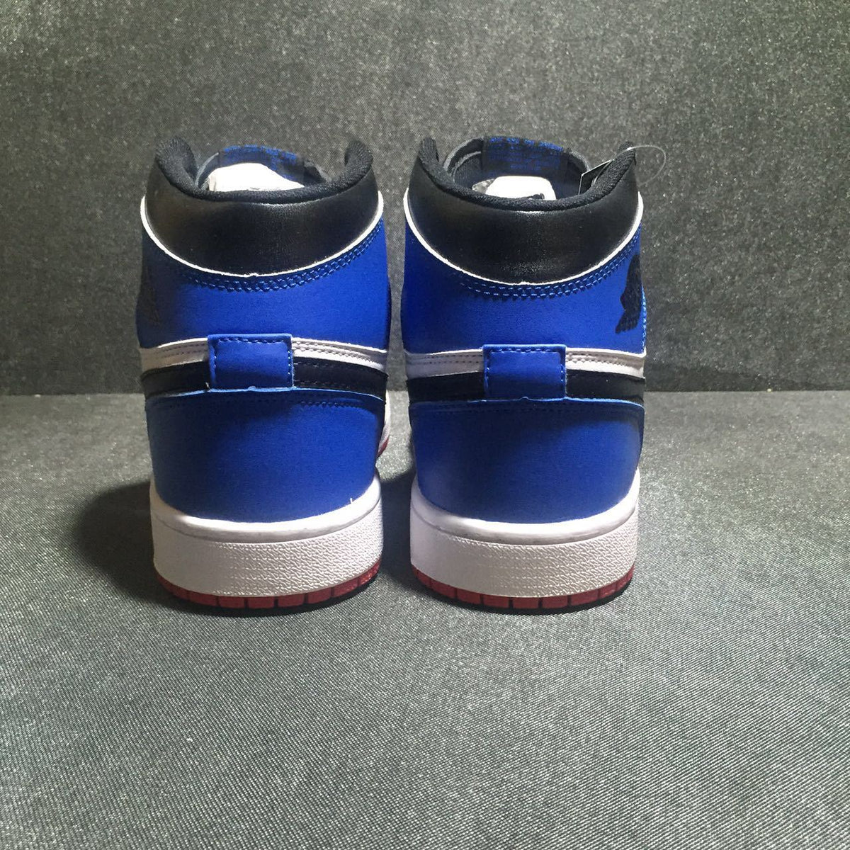 Jordan 1 High Three-Color Sneaker in Black, in Blue and Red - product image from the listing.