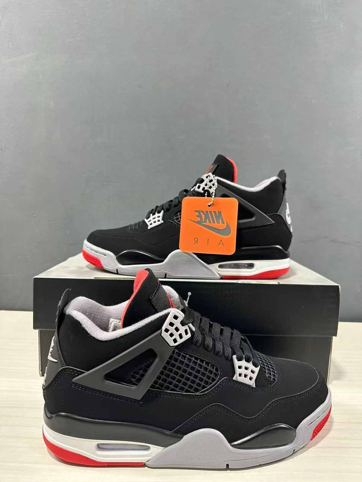 Air Jordan 4 Retro Bred Black Red Sneakers IX8180-001 - product image from the listing.