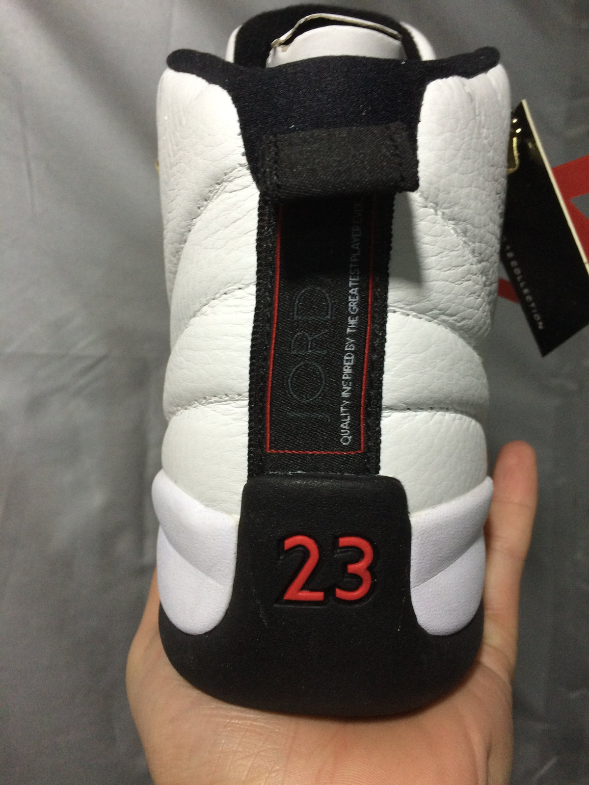 Air Jordan 12 Retro White and Black High-Top Sneakers - product image from the listing.