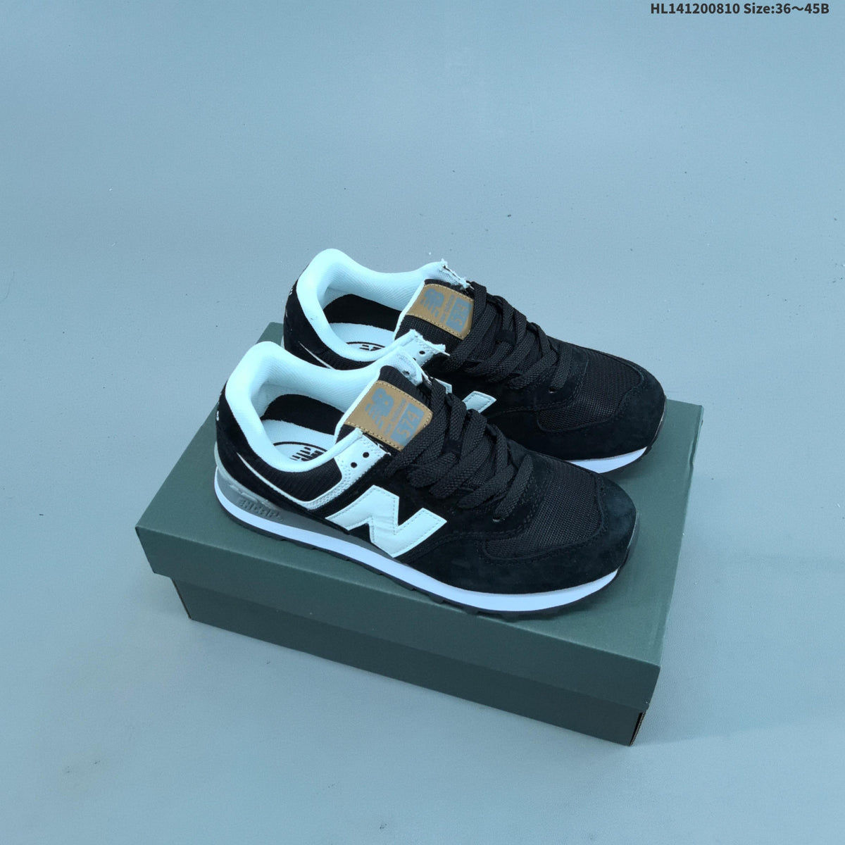 New Balance 574 Retro Sneakers in Black, Grey or in Cream - product image from the listing.