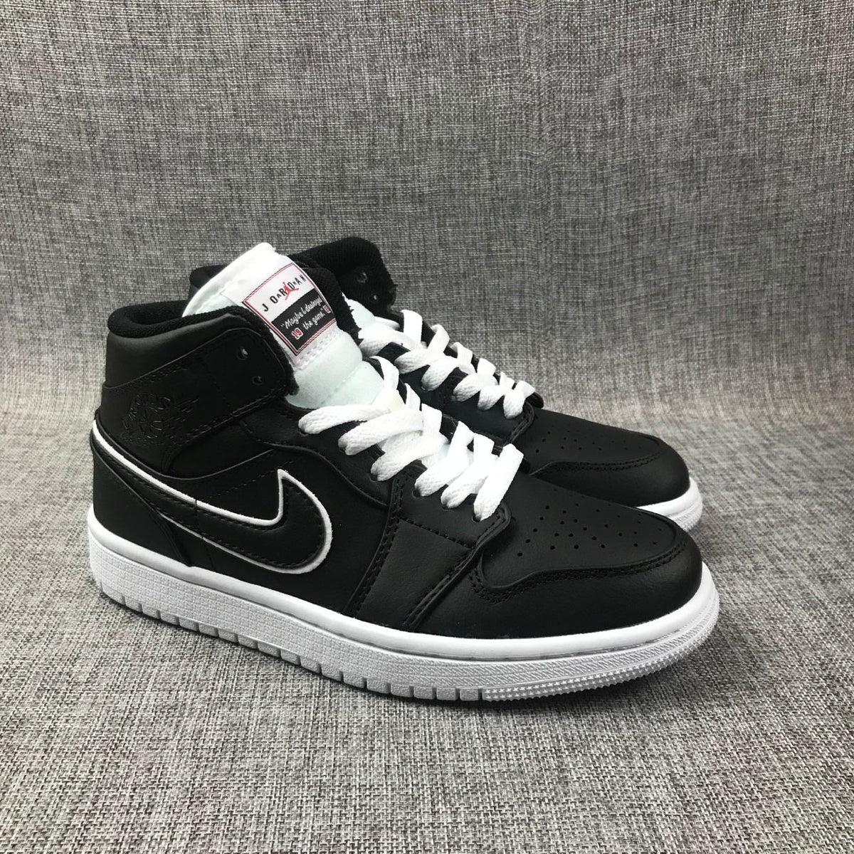 Air Jordan 1 Mid Sneakers in Black and White 852542-016 - product image from the listing.