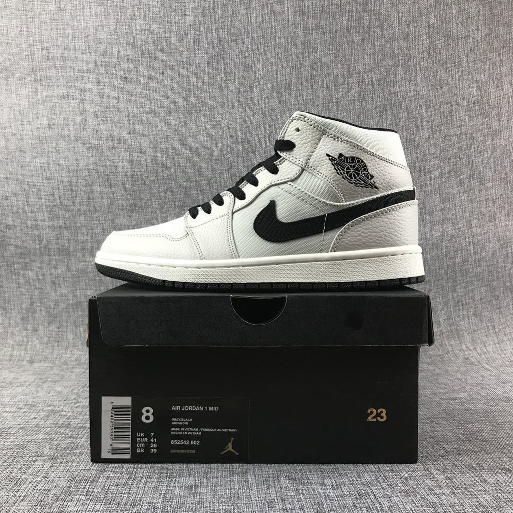 Air Jordan 1 Mid High-Top Sneakers in Grey and Black - product image from the listing.