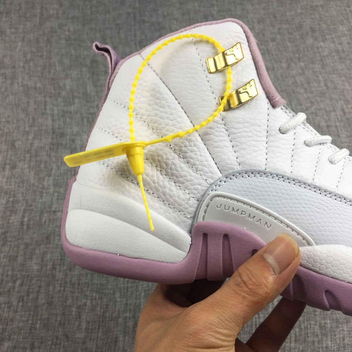 Air Jordan 12 Cherry Blossom Pink Sneakers - product image from the listing.
