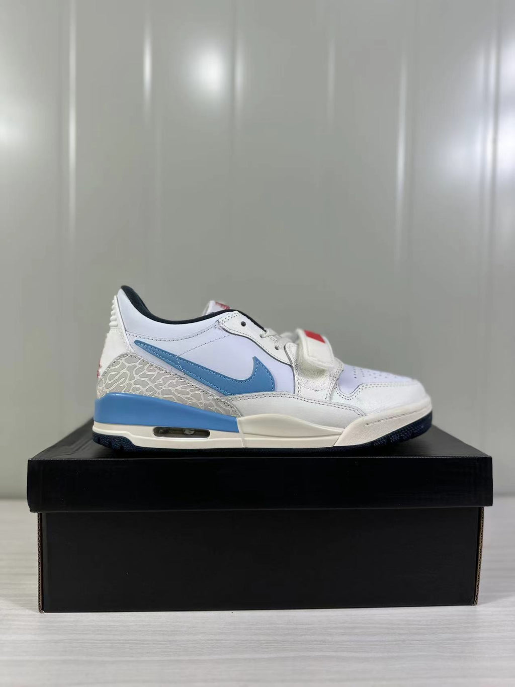Jordan Legacy 312 Low in White Blue Red HM3709-141 - product image from the listing.