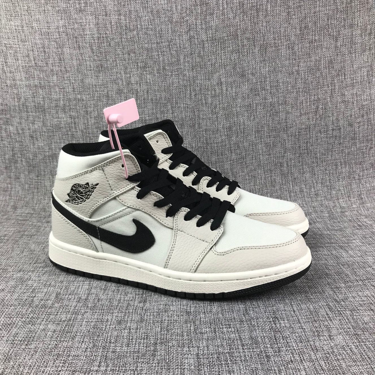 Air Jordan 1 Mid High-Top Sneakers in Grey and Black - product image from the listing.