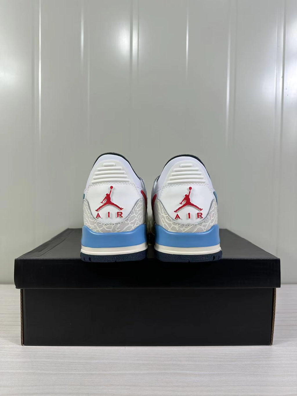 Jordan Legacy 312 Low in White Blue Red HM3709-141 - product image from the listing.