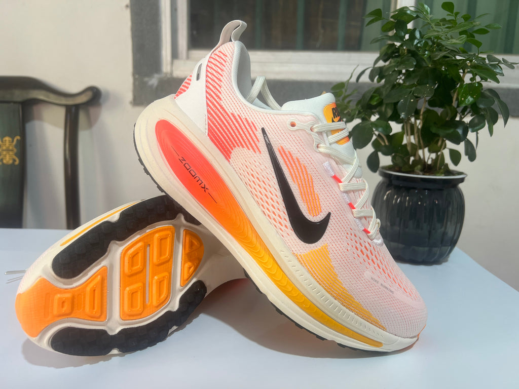Nike Vomero 18 Running Shoes, in White and Coral - product image from the listing.