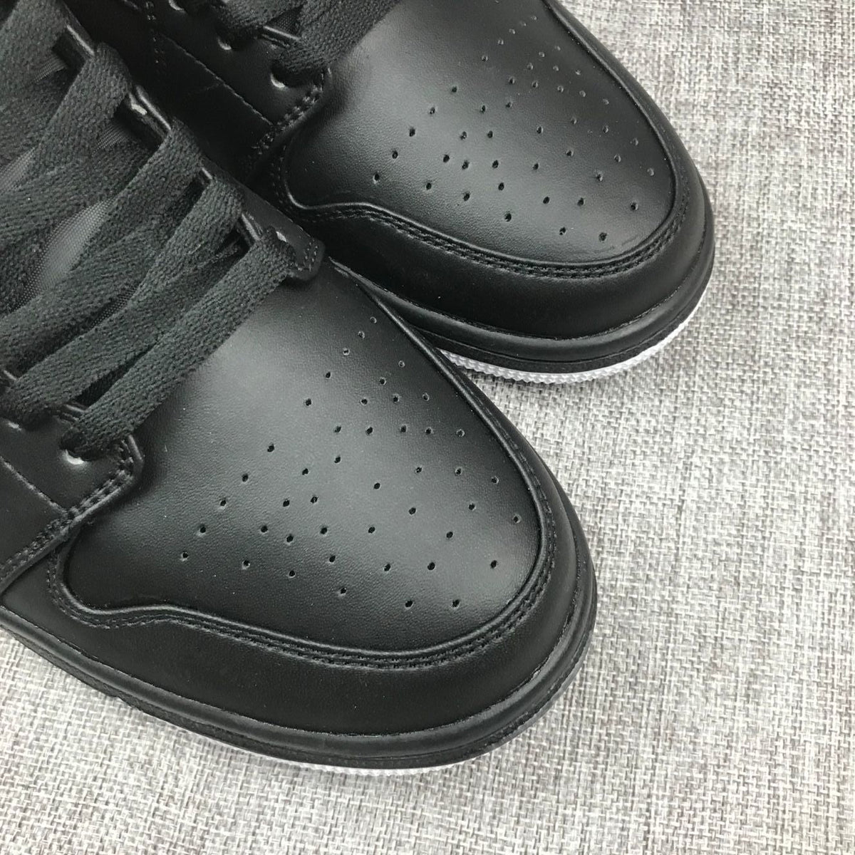 Air Jordan 1 Mid Sneakers in Black and Red 554724-045 - product image from the listing.