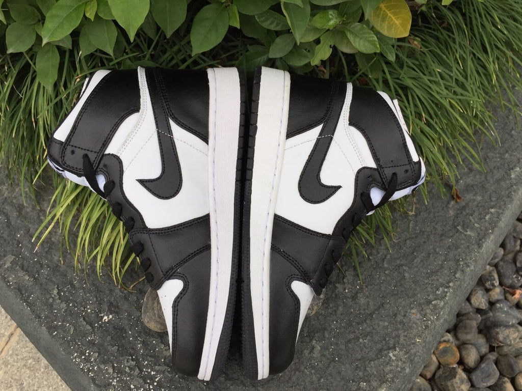 Women's Jordan 1 High Black and White Sneakers - product image from the listing.