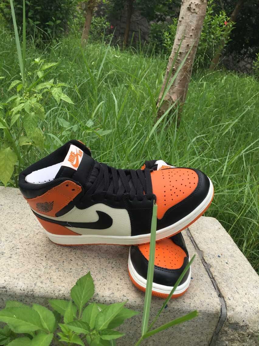 Jordan 1 High Sneakers in Black, in White and Orange - product image from the listing.