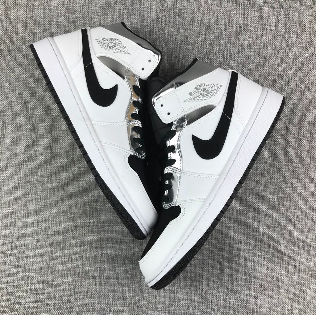 Air Jordan 1 Mid Sneakers in White and Black - product image from the listing.