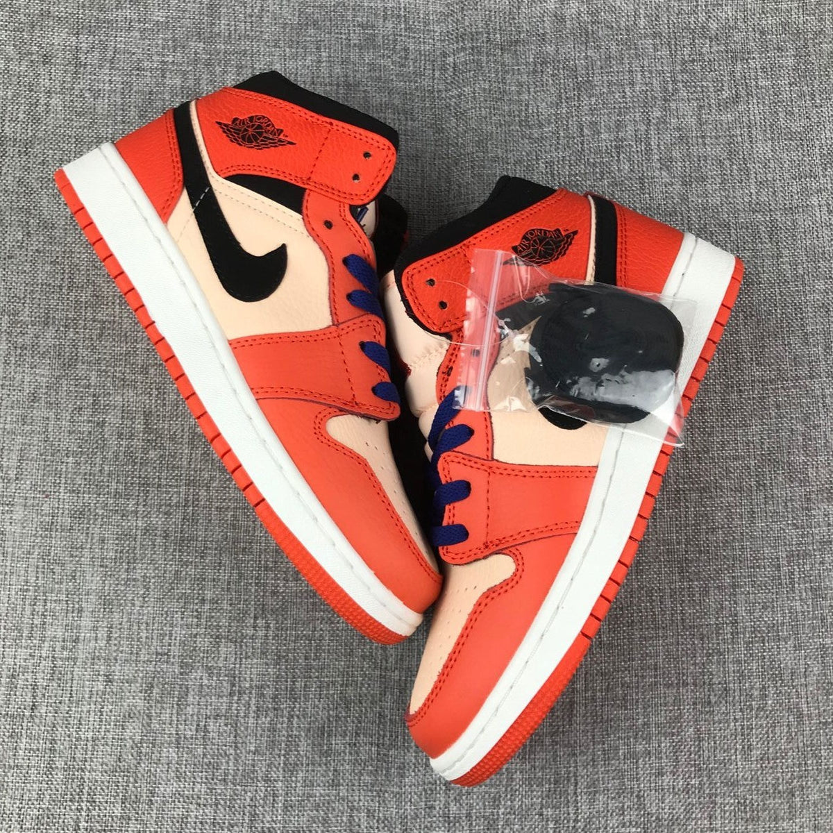 Air Jordan 1 Mid GS Sneakers in Pink and Orange - product image from the listing.