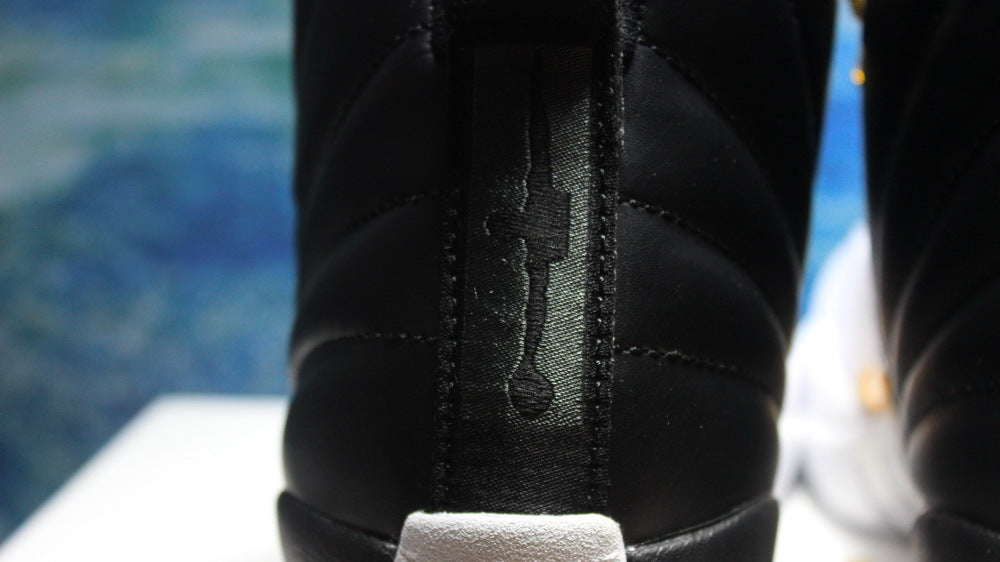 Air Jordan 12 Wings Black White Gold Sneakers 848692-033 - product image from the listing.