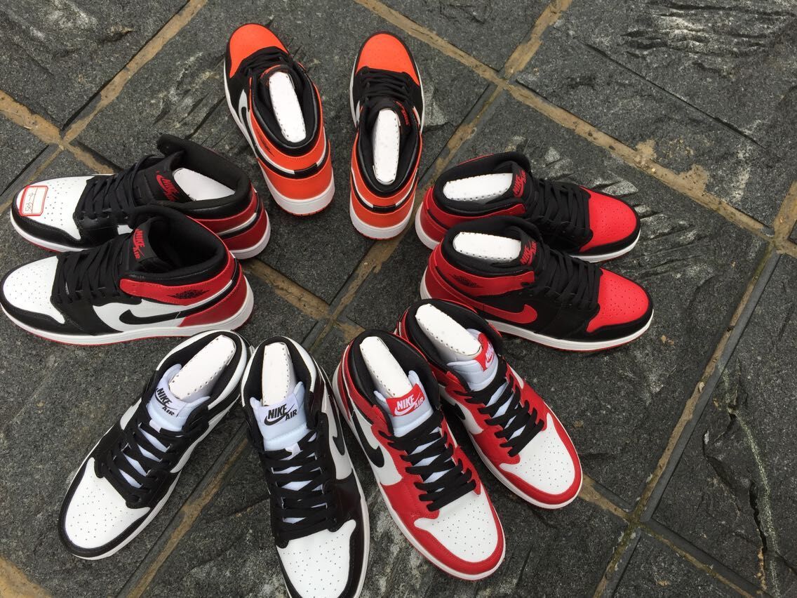 Women's Jordan 1 High Black Orange White Sneakers - product image from the listing.