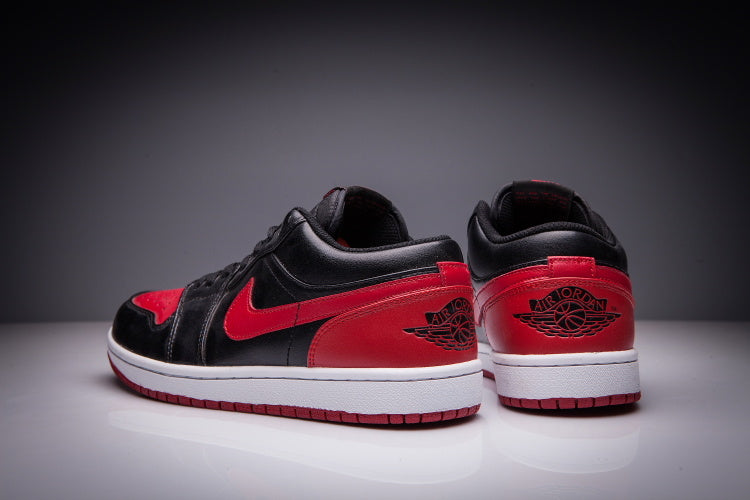 Jordan 1 Low Sneakers in Black and Red - product image from the listing.