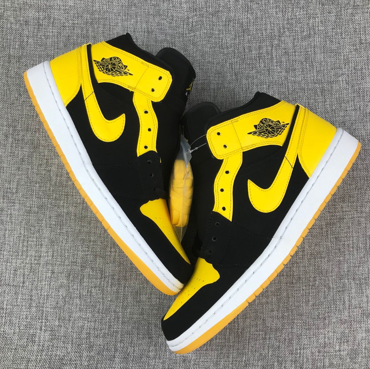 Air Jordan 1 Mid Sneakers in Black and Yellow - product image from the listing.