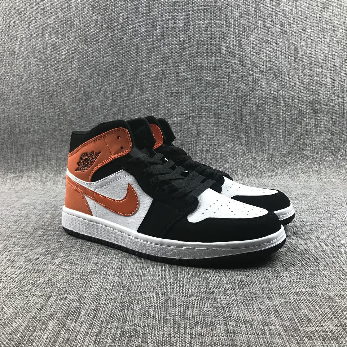 Air Jordan 1 Mid Sneakers in Black White Orange 554724-058 - product image from the listing.