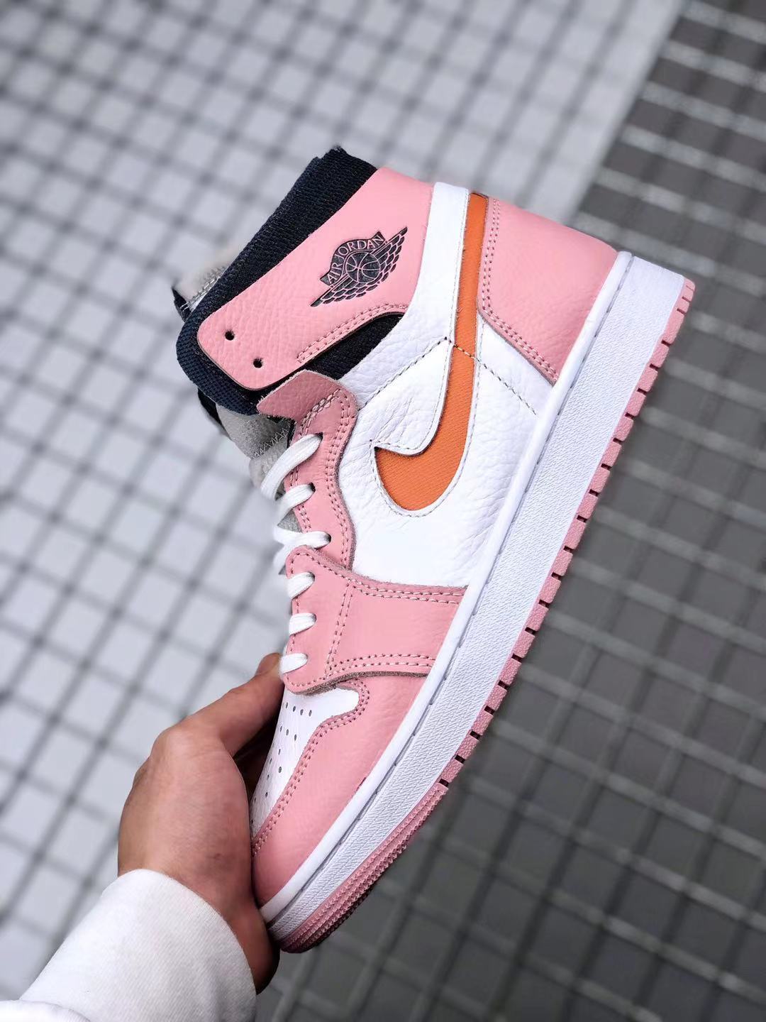 Jordan 1 High Zoom CMFT Sneakers in Pink White Orange CT0979-601 - product image from the listing.