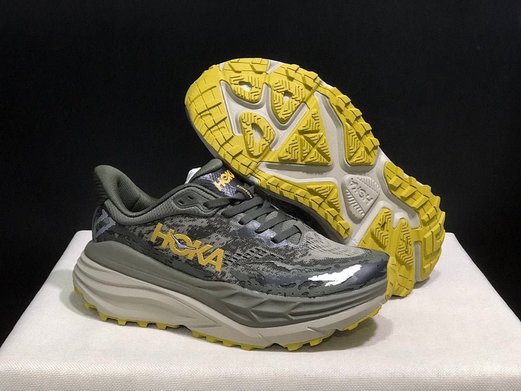 HOKA Stinson 7 Trail Running Shoes, in Gray and Yellow - product image from the listing.