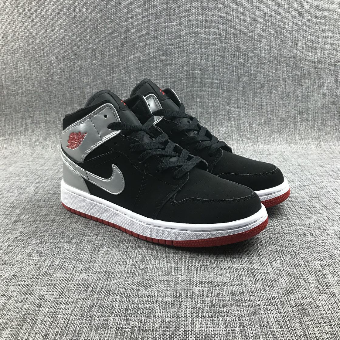 Air Jordan 1 Mid SE GS Sneakers in Black Silver 554725-057 - product image from the listing.