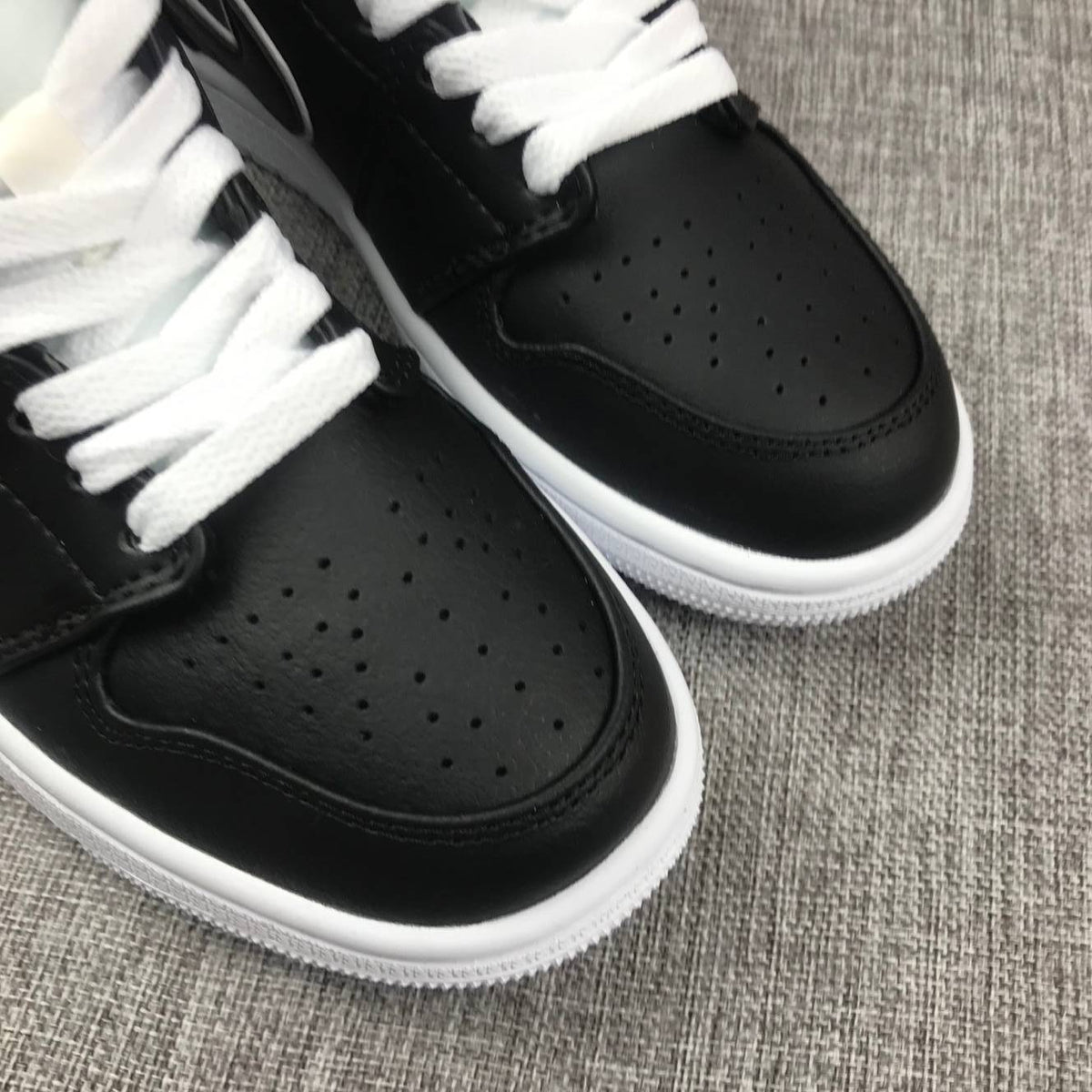 Air Jordan 1 Mid Sneakers in Black and White 852542-016 - product image from the listing.
