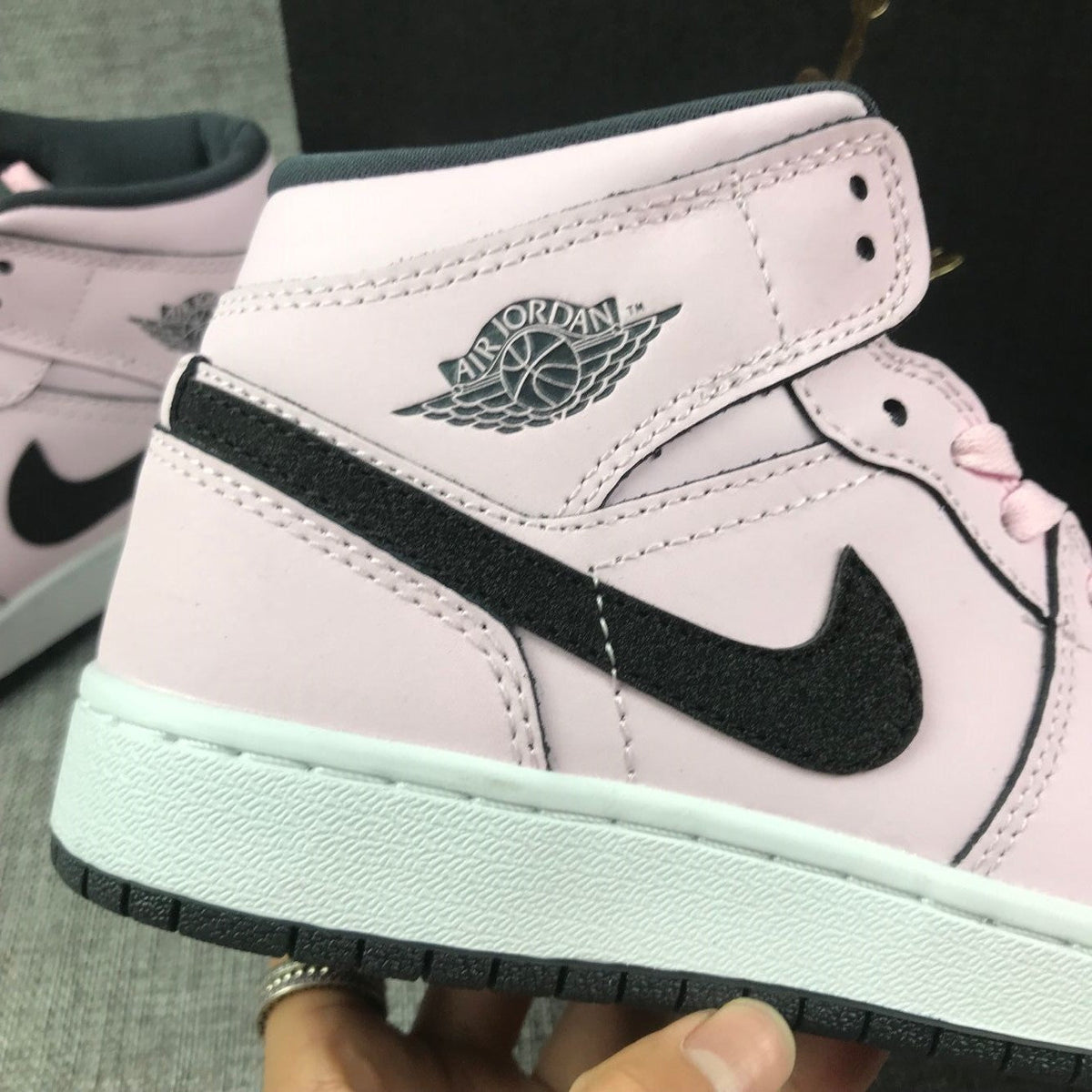 Air Jordan 1 Mid High-Top Sneakers in Pink and Black - product image from the listing.